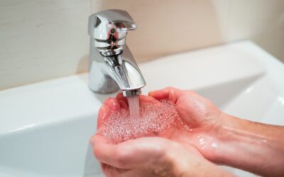 Closeup shot of a person washing hands in the sink